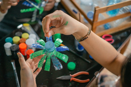 close up woman hand holding craft from plastic bottle wasteの写真素材