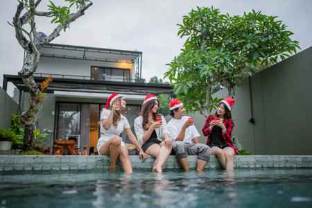 young people having fun at christmas pool partyの写真素材