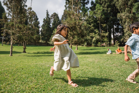 Children enjoy a delightful and carefree day playing joyfully in the lush green park area