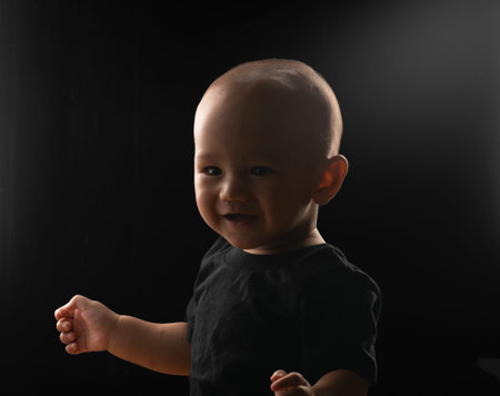 A cheerful baby is joyfully enjoying playtime in a softly lit environment, radiating happiness