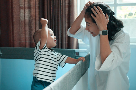 A mother shares a joyful, intimate moment with her child, showcasing their deep bondの写真素材