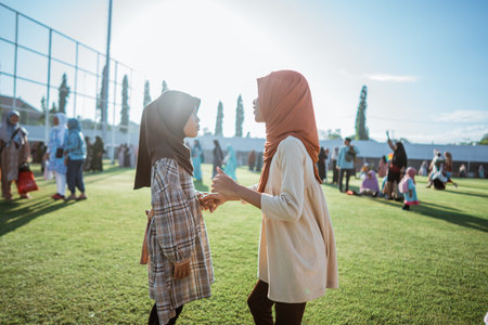 Two young girls joyfully enjoy a sunny day, capturing the essence of their friendshipの写真素材
