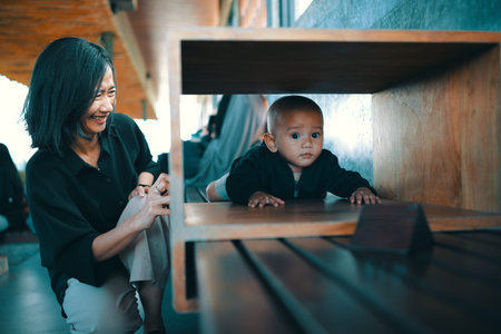 A loving mother enjoys cherished playful moments with her curious baby in a modern home setting