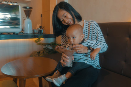 A loving mother enjoys a warm moment filled with joy with her happy child at a cozy cafe