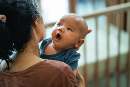 A heartwarming moment between a mother and baby, showcasing their joy and beautiful bond