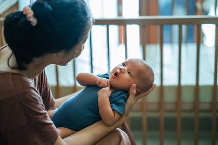 A heartwarming moment between a loving mother and her adorable baby in a cozy settingの写真素材