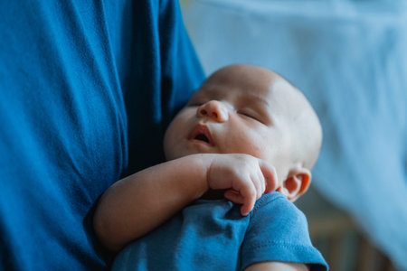 A peaceful baby sleeping in a parents loving embrace, showcasing deep love and serenity
