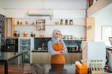 beautiful Asian woman cafe waitress wearing apron standing in coffee cafeの写真素材