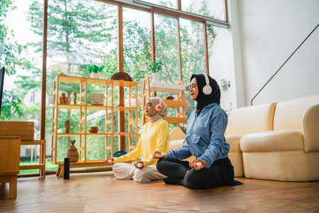 Two individuals are practicing mindfulness together in a calming home environmentの写真素材