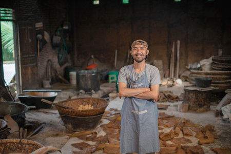 A craftsman poses proudly in a workshop filled with tools and traditional materials.