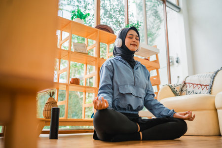 A peaceful and serene moment of meditation indoors while wearing comfortable headphonesの写真素材