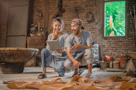 A group of skilled artisans collaborates harmoniously in a cozy workshop, utilizing technology