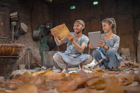 Two artisans are collaborating in a vibrant workshop full of creativity and innovation