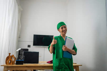 A smiling healthcare worker in scrubs, showcasing positivity and professionalism.の写真素材