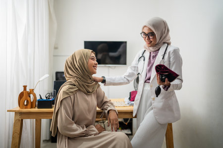 In a warm and welcoming clinic, a compassionate female doctor thoughtfully engages with her patientの写真素材