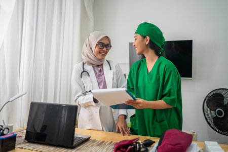Two healthcare professionals are discussing patient care in a modern healthcare settingの写真素材
