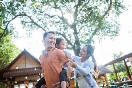 asian little family playing together in the yard, family conceptの写真素材