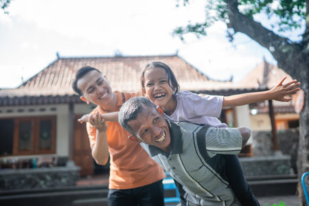 three generation family having fun together in outdoorsの写真素材
