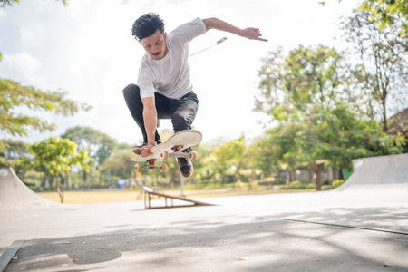 A vibrant and dynamic moment of skateboarding, beautifully captured in a sunlit park settingの写真素材