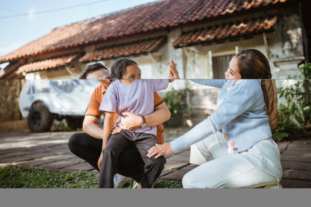 young girl high five with her mother on leisure timeの写真素材