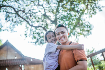 lovely asian father and daughter hugging each other, low angle viewの写真素材