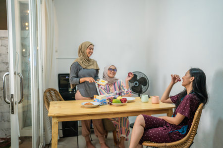 Family members enjoy a delightful meal together in a warm and cozy kitchen atmosphereの写真素材