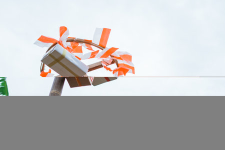 several boxes containing gifts hanging above the areca Climbing arena with the flag on a white sky backgroundの写真素材