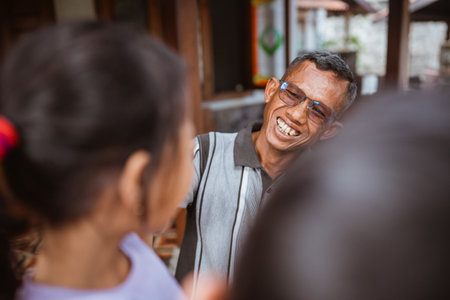 close up view of happy asian grandfather greeting his grandchild and sonの写真素材