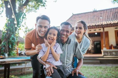 happy kid with grandfather and young parentの写真素材