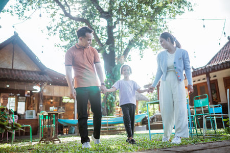 asian little family enjoying leisure time in outdoors