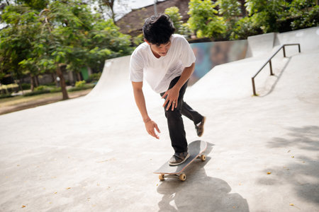A skilled skater performing impressive tricks in a vibrant skate park beneath clear blue skiesの写真素材