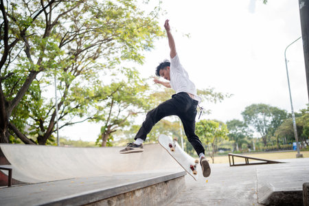 A young and talented skateboarder is showcasing amazing skills in an urban skate park settingの写真素材