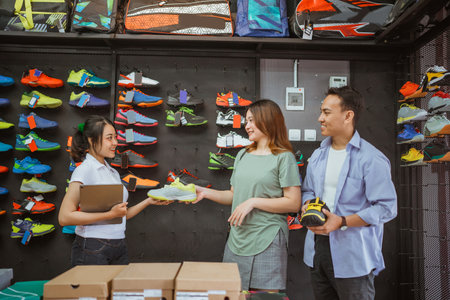 asian customer hand over choosen shoe product to saleswomanの写真素材