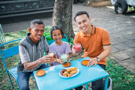 high angle view asian family enjoying lunch together in a cafeの写真素材