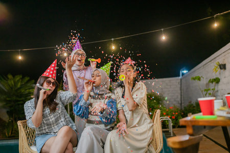 Friends gather for a vibrant outdoor party filled with festive accessories and joyful momentsの写真素材