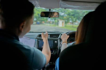 A driving instructor skillfully guides a student as they navigate through a busy parking lot