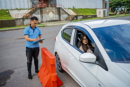 A traffic officer checks a drivers details at a control checkpoint for compliance and safetyの写真素材