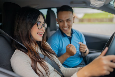 A couple joyfully sharing a moment while driving down a scenic road, enjoying the rideの写真素材
