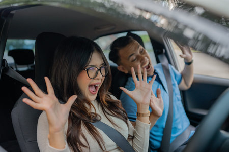 Two close friends joyfully singing together in a car, celebrating fun and spontaneity
