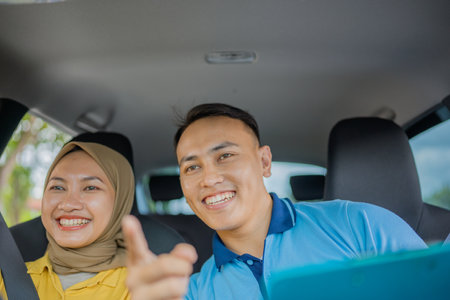 Friends joyfully sharing smiles and laughter on a fun car ride during their adventureの写真素材