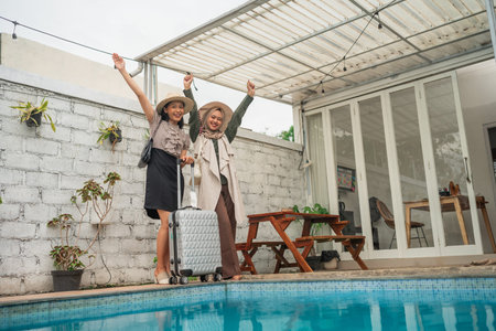 Two cheerful travelers pose by the pool, ready for their next exciting adventure