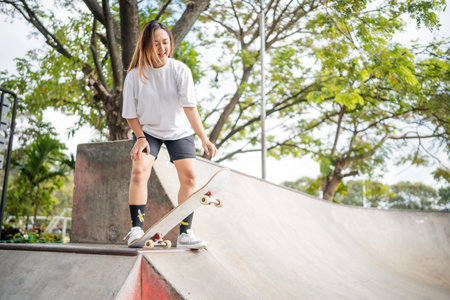 An energetic skateboarder is catching big air in a vibrant and lively skatepark settingの写真素材