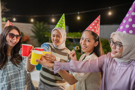 A joyful group of friends enjoying a lively celebration with drinks, laughter, and joyの写真素材