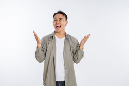 A man joyfully expressing excitement and surprise with open arms against a white background.