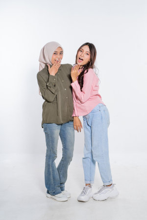 Two fashionable women pose playfully, showcasing the vibrant essence of modern friendshipの写真素材