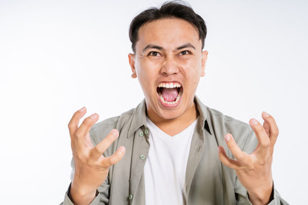 A man showcases intense emotions, vividly conveying anger and frustration, captivating othersの写真素材