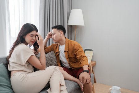 Couple sharing a serious moment, emphasizing emotional connection and communication.の写真素材