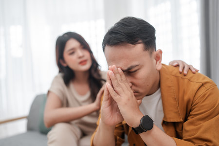 A couple experiences emotional tension, with support and understanding in focus.の写真素材