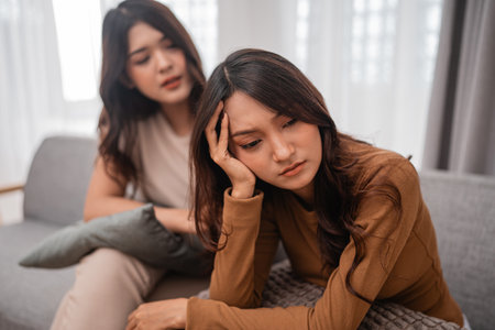 Two women engage in a deeply heartfelt and meaningful conversation in the warmth of their homeの写真素材