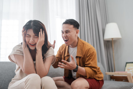 A couple is experiencing heightened tension and conflict at home, affecting their relationshipの写真素材